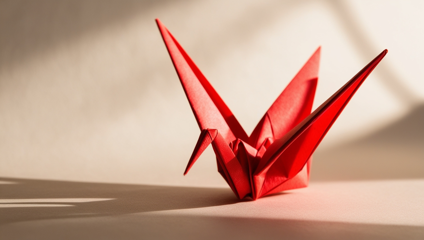 Red origami crane symbolizing peace and hope